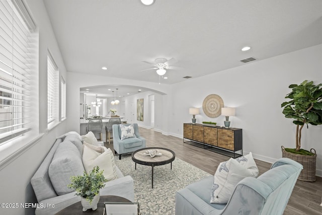 107 Park Lake Dr, Ponte Vedra, FL 32081 - living area with arched walkways, a ceiling fan, wood finished floors, a chandelier, and recessed lighting