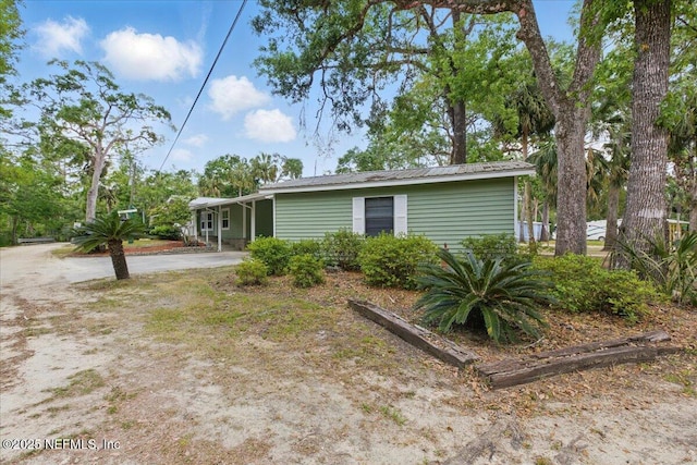 1418 Palm St NE, Steinhatchee, FL 32359 - view of front of house with metal roof and driveway