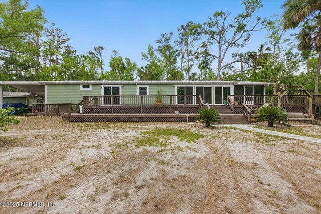 1418 Palm St NE, Steinhatchee, FL 32359 - manufactured / mobile home featuring a sunroom and a deck