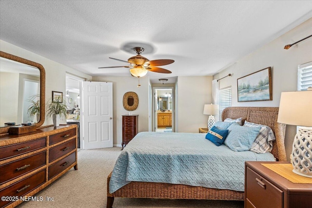 1418 Palm St NE, Steinhatchee, FL 32359 - bedroom featuring light carpet, ensuite bath, a ceiling fan, and a textured ceiling