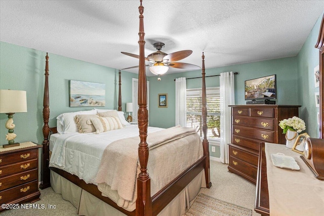 1418 Palm St NE, Steinhatchee, FL 32359 - bedroom featuring light colored carpet, a textured ceiling, and a ceiling fan