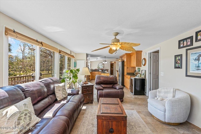 1418 Palm St NE, Steinhatchee, FL 32359 - living room with ceiling fan, a textured ceiling, and light stone finish floors
