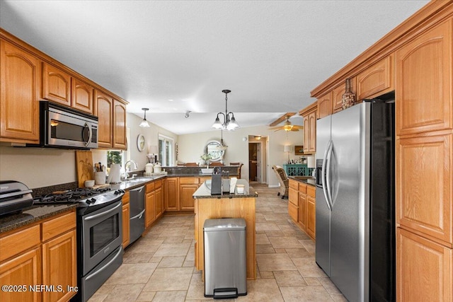 1418 Palm St NE, Steinhatchee, FL 32359 - kitchen with stainless steel appliances, a sink, a peninsula, and brown cabinets