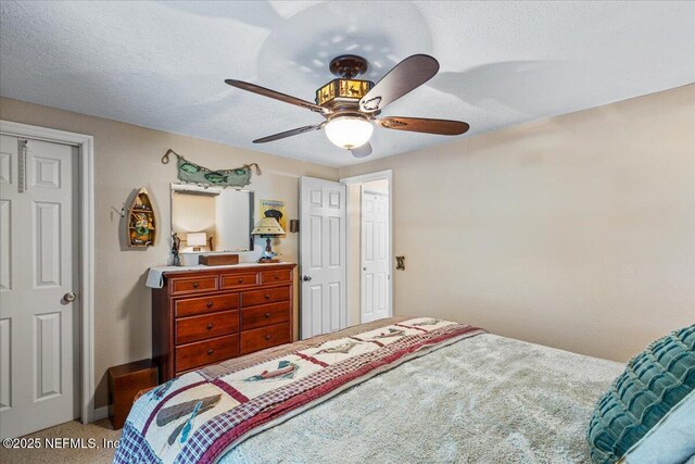 1418 Palm St NE, Steinhatchee, FL 32359 - bedroom with carpet, ceiling fan, and a textured ceiling
