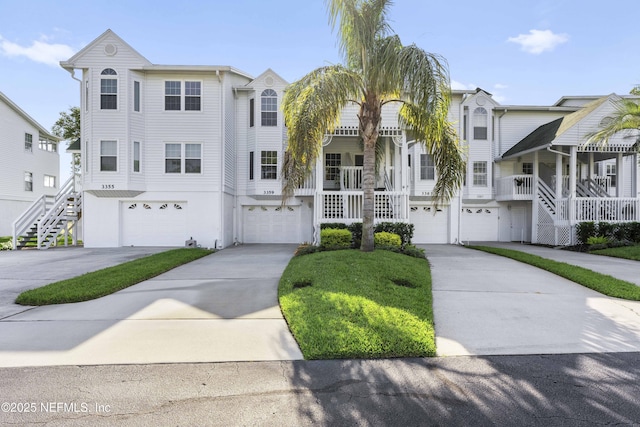 3359 Lighthouse Point Ln, Jacksonville, FL 32250 - view of front of property featuring a garage, concrete driveway, and stairs
