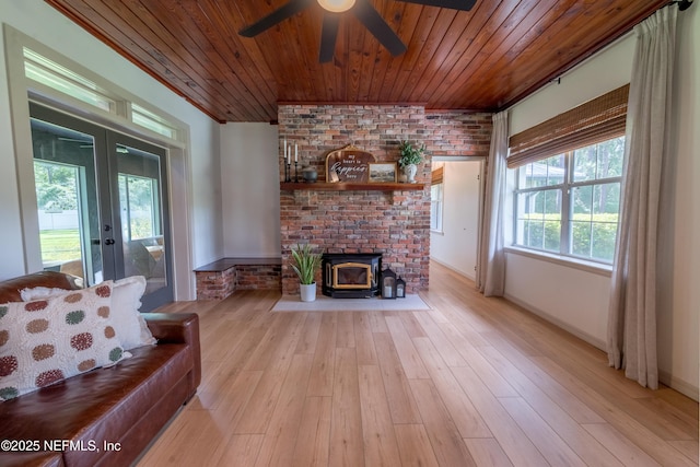 1525 E Call St, Starke, FL 32091 - living area featuring french doors, wooden ceiling, a ceiling fan, a wood stove, and light wood finished floors