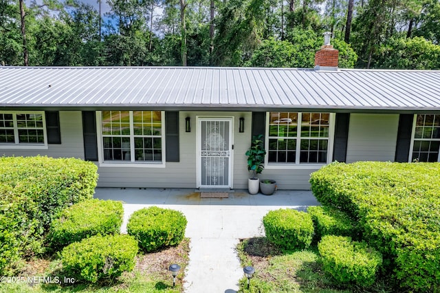 1525 E Call St, Starke, FL 32091 - view of front of property with a chimney and metal roof