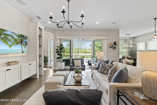 living area with a chandelier, dark wood finished floors, and recessed lighting