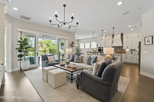 living room with a chandelier, recessed lighting, dark wood finished floors, and baseboards