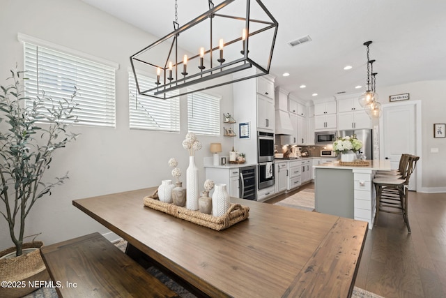 dining room with wine cooler, light wood finished floors, and recessed lighting