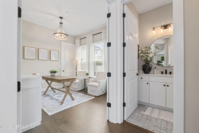 entrance foyer with dark wood finished floors and a chandelier