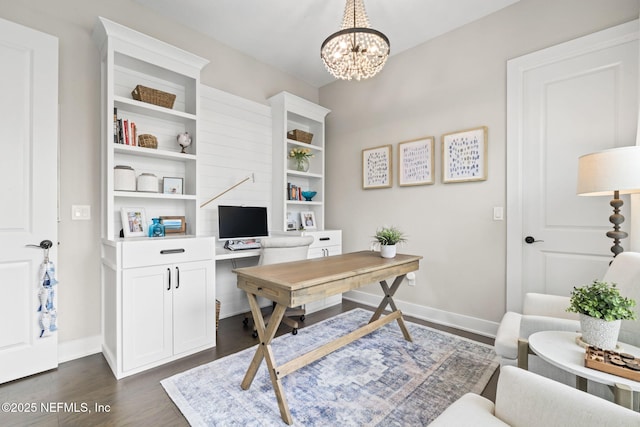 home office with dark wood-style flooring, a chandelier, and baseboards