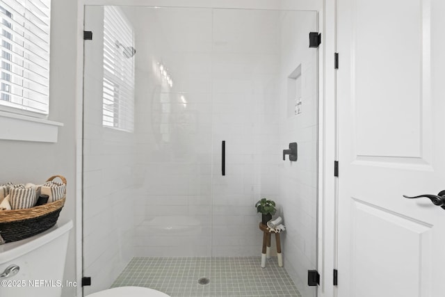 full bath with toilet and a shower stall
