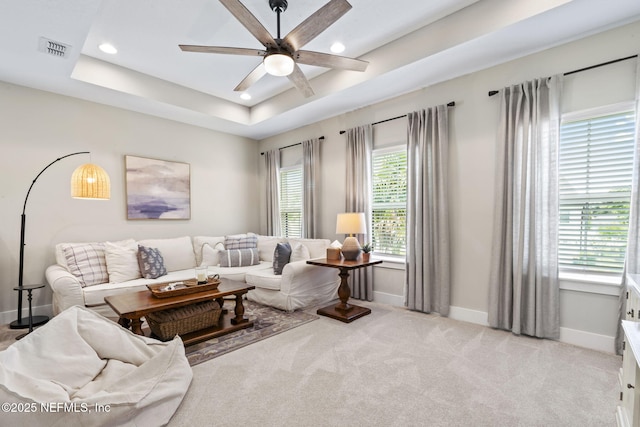 living area featuring baseboards, a ceiling fan, recessed lighting, and light carpet