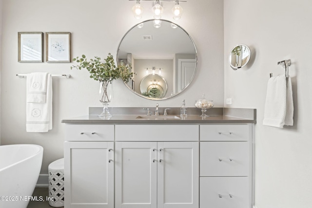 bathroom featuring vanity and a soaking tub