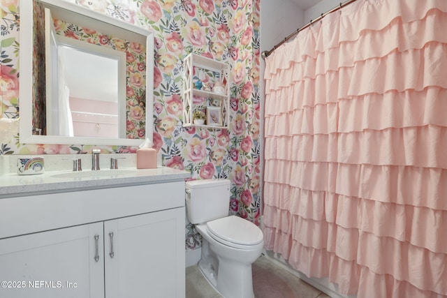 bathroom featuring wallpapered walls, toilet, vanity, tile patterned floors, and a shower with curtain