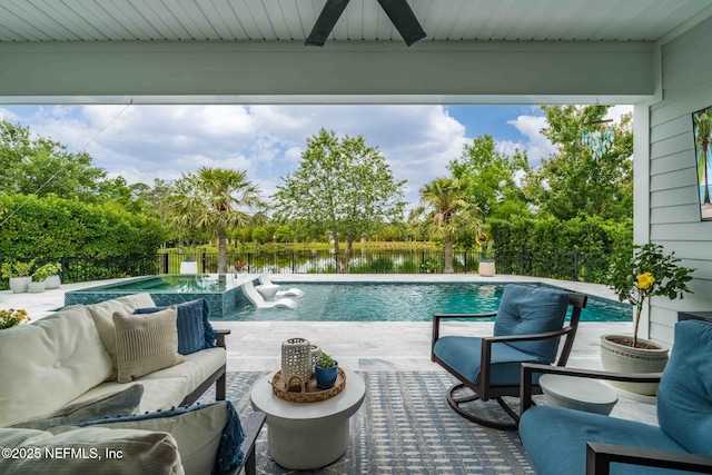 view of pool with a water view, a ceiling fan, outdoor lounge area, and a fenced backyard