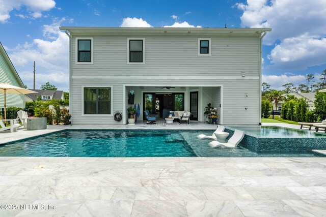 rear view of house with a patio, outdoor lounge area, a ceiling fan, and a pool with connected hot tub