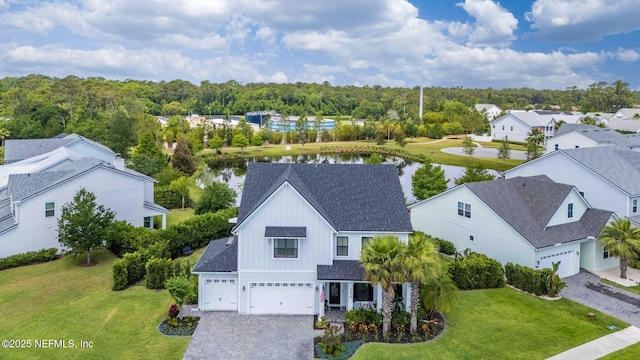 aerial view of residential area featuring a large body of water