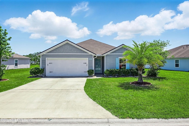 view of front of house with an attached garage, driveway, and a front lawn