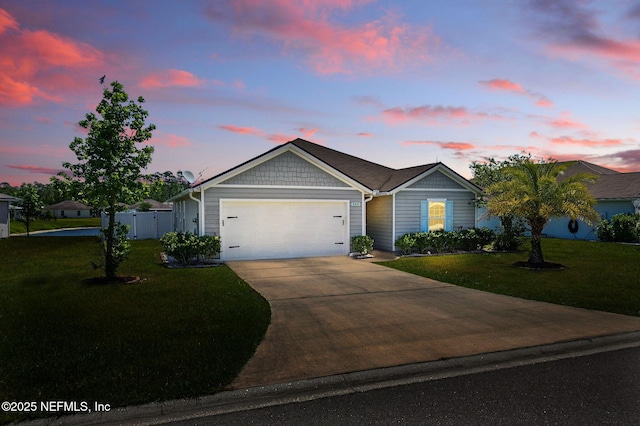 ranch-style house featuring an attached garage and driveway