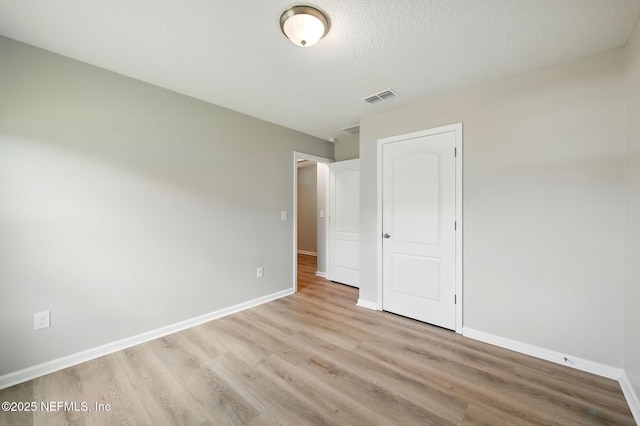 unfurnished bedroom featuring light wood-style flooring and baseboards