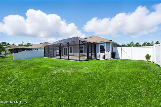 rear view of house with a lanai and a patio area