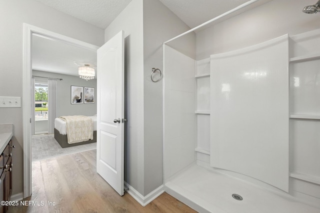 full bath with wood finished floors, a shower, ensuite bathroom, and vanity