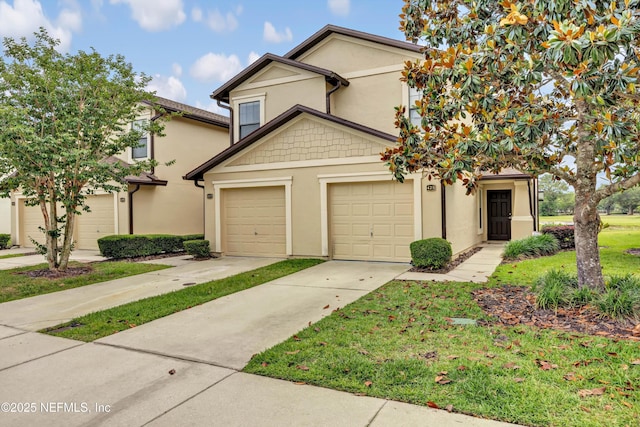 view of front facade with concrete driveway, stucco siding, and a front yard