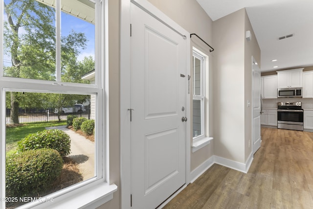 1339 Date St, Fernandina Beach, FL 32034 - doorway with wood finished floors, baseboards, and recessed lighting