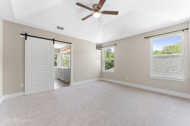 1339 Date St, Fernandina Beach, FL 32034 - unfurnished room featuring carpet flooring, a ceiling fan, a barn door, and baseboards