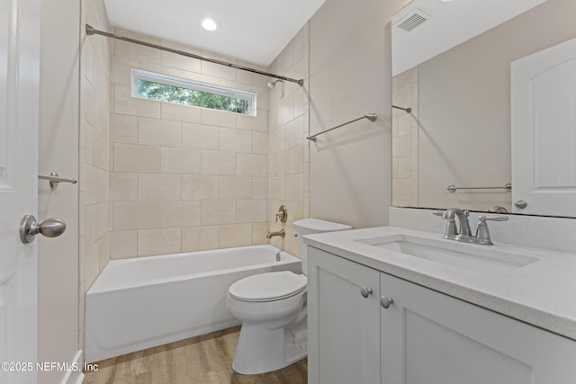 1339 Date St, Fernandina Beach, FL 32034 - bathroom with toilet, vanity, tub / shower combination, and wood finished floors