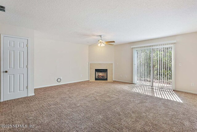 452 Dutton Island Rd W, Atlantic Beach, FL 32233 - unfurnished living room featuring ceiling fan, carpet floors, a textured ceiling, a tile fireplace, and baseboards