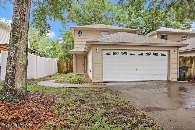 452 Dutton Island Rd W, Atlantic Beach, FL 32233 - view of front of house with driveway, fence, an attached garage, and roof with shingles
