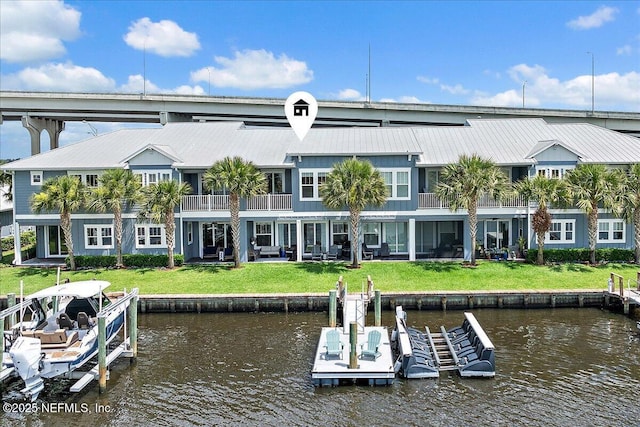 2540 Beach Blvd, Jacksonville Beach, FL 32250 - back of property featuring a water view, metal roof, boat lift, and a yard