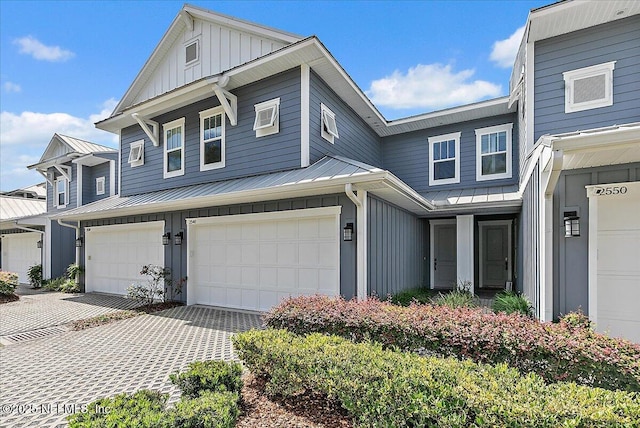2540 Beach Blvd, Jacksonville Beach, FL 32250 - view of front of property featuring board and batten siding, a standing seam roof, metal roof, and an attached garage