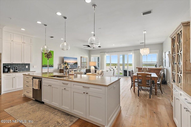 2540 Beach Blvd, Jacksonville Beach, FL 32250 - kitchen featuring a sink, stainless steel dishwasher, light wood-style flooring, recessed lighting, and an island with sink