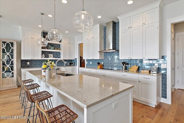 2540 Beach Blvd, Jacksonville Beach, FL 32250 - kitchen featuring a sink, wall chimney exhaust hood, open shelves, light wood-style floors, and recessed lighting