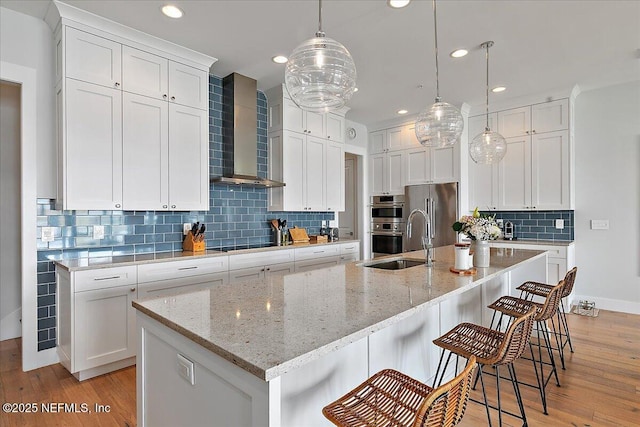 2540 Beach Blvd, Jacksonville Beach, FL 32250 - kitchen featuring wall chimney exhaust hood, stainless steel appliances, a sink, light wood-style flooring, and recessed lighting