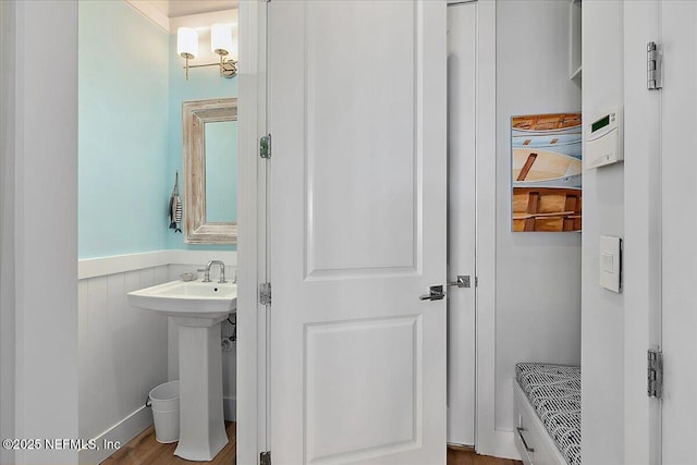 2540 Beach Blvd, Jacksonville Beach, FL 32250 - bathroom featuring a wainscoted wall and wood finished floors