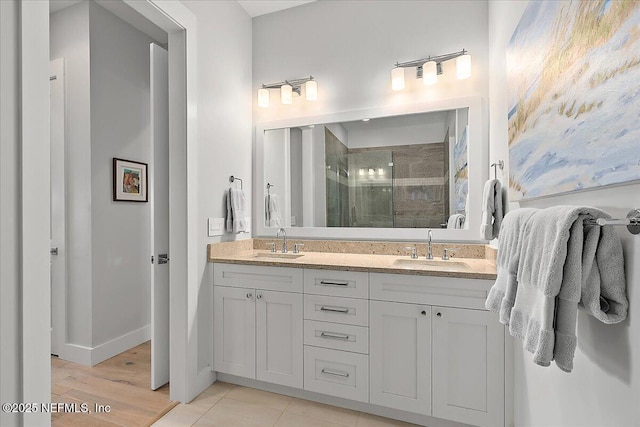 2540 Beach Blvd, Jacksonville Beach, FL 32250 - bathroom featuring a shower stall, double vanity, and wood finished floors