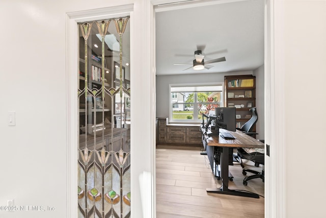 home office featuring a ceiling fan and wood finished floors