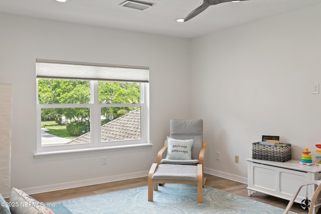 living area featuring wood finished floors, baseboards, ceiling fan, and recessed lighting