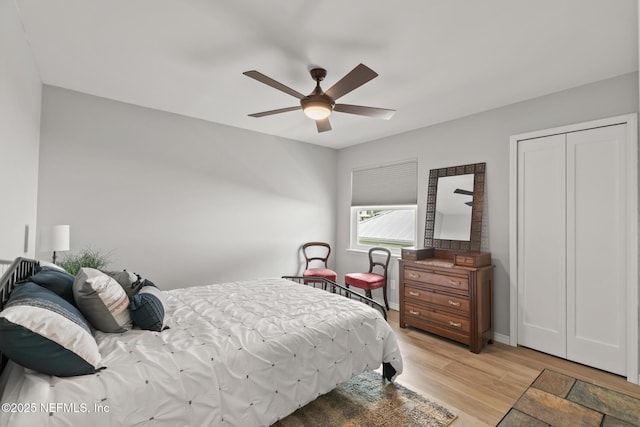 bedroom with light wood finished floors, a ceiling fan, and baseboards
