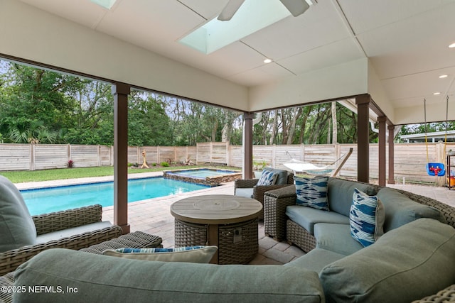 view of pool featuring an outdoor living space, an in-ground hot tub, a fenced backyard, a patio, and a ceiling fan