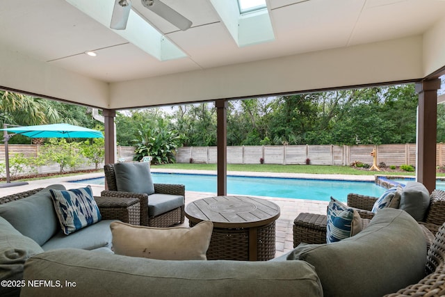 view of pool featuring a fenced backyard, an outdoor hangout area, and a ceiling fan