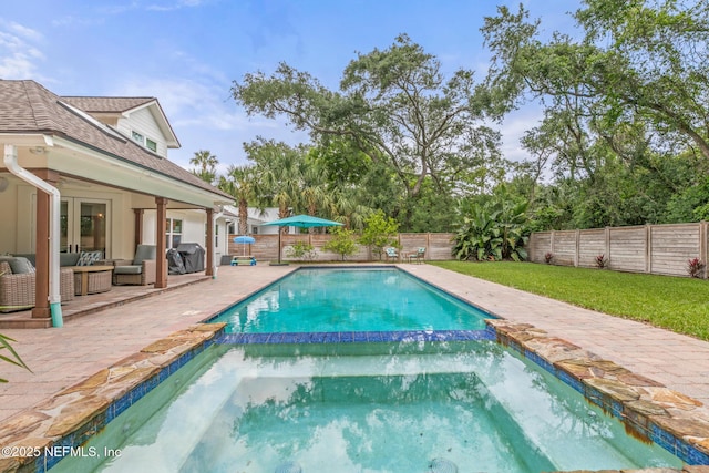 view of swimming pool featuring an outdoor living space, a pool with connected hot tub, a patio area, and area for grilling