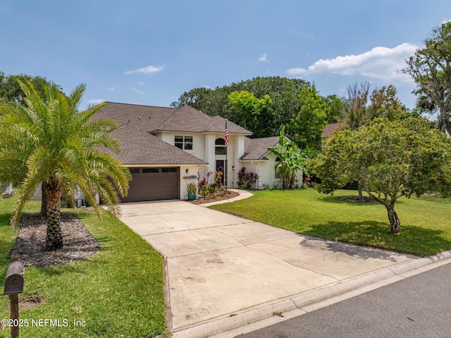 view of front of home featuring driveway, a garage, a front yard, stucco siding, and a shingled roof