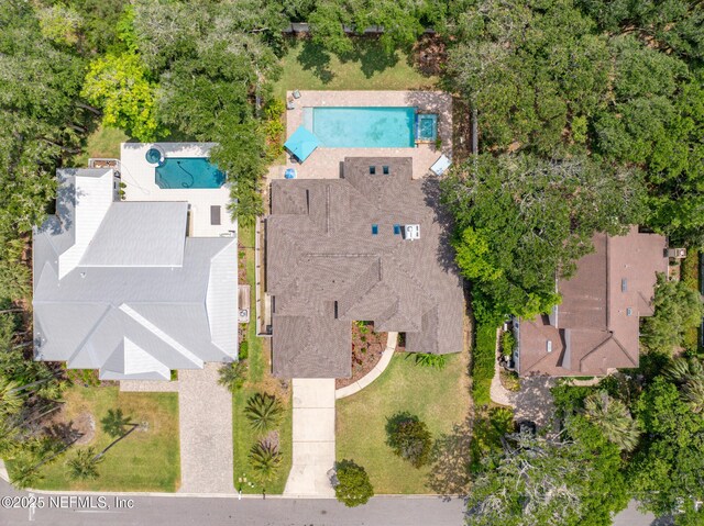 aerial view of property and surrounding area with a pool area