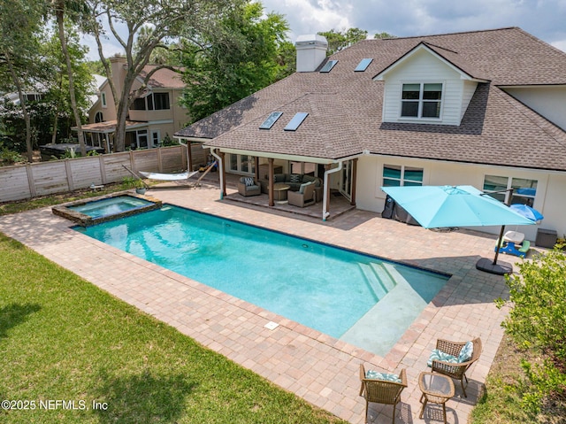 view of pool featuring an outdoor living space, a patio area, and a pool with connected hot tub